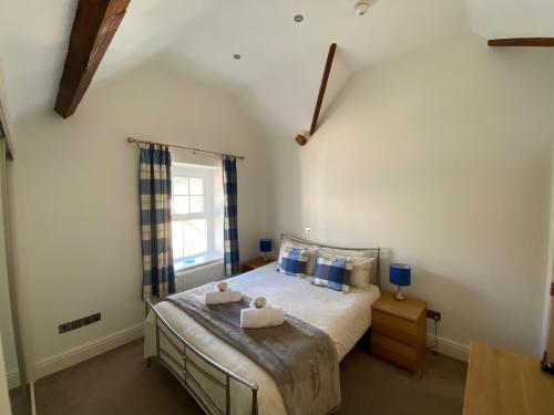 a bedroom with a bed with two towels on it at Southover Beach in Woolacombe