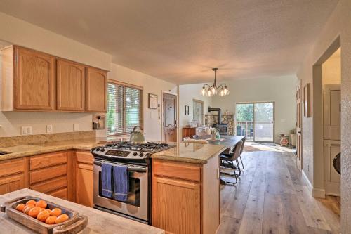 a large kitchen with wooden cabinets and a counter top at Near Hiking and Wineries Arnold Cabin with Deck! in Arnold