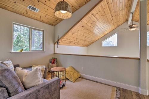 a living room with a couch and a wooden ceiling at Near Hiking and Wineries Arnold Cabin with Deck! in Arnold