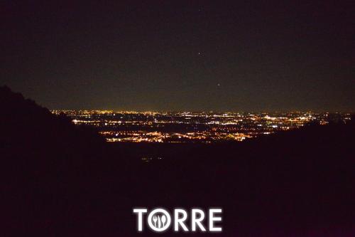 a view of a city at night with the word toore at Albergo Torre in Vicenza
