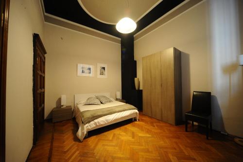 a bedroom with a bed and a lamp at Le Muse in Brescia