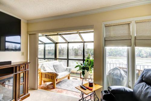 a living room with large windows and a couch at Waterfront Vacation Rental on Savannah River! in Augusta
