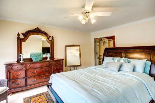 a bedroom with a bed and a dresser and a mirror at Waterfront Vacation Rental on Savannah River! in Augusta