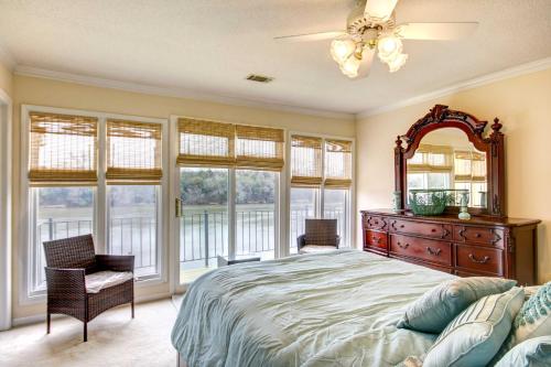 a bedroom with a bed and a mirror and windows at Waterfront Vacation Rental on Savannah River! in Augusta