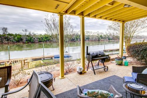 a patio with a grill and a view of a river at Waterfront Vacation Rental on Savannah River! in Augusta