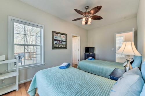 a bedroom with two beds and a ceiling fan at Lakefront Lexington House with Spacious Deck! in Lexington