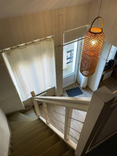 une chambre avec un escalier et un lustre dans l'établissement Appartement Duplex refait à neuf, à Saint-Malo
