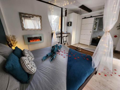 a bedroom with a bed with red flowers on it at A l'Orée des pins - Gite et spa de 30 m2- Home Cinéma et massage en sup in Cuges-les-Pins