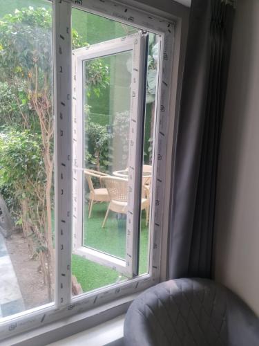 a room with a window with a chair and a table at City View With Garden -5 Mins Walk From GOLDEN TEMPLE in Amritsar