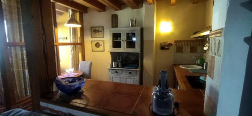 a kitchen with a wooden counter top in a room at El Balconcillo-Los Sitios de Aravalle in Umbrías