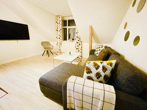 a living room with a couch and a flat screen tv at aday - Cozy central 1 bedroom apartment in Frederikshavn