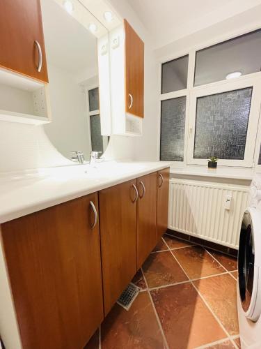 a bathroom with a sink and a washing machine at aday - Cozy central 1 bedroom apartment in Frederikshavn