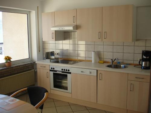 a kitchen with a sink and a stove top oven at Ferienwohnung Jansen in Kirchhundem