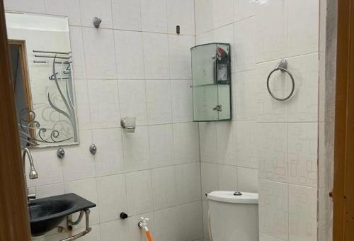 a bathroom with a shower and a toilet and a mirror at La wood homestay in Kuala Besut