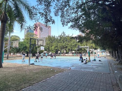 a group of people playing basketball on a basketball court at Hotel Sunshine in Kaohsiung
