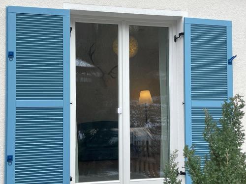 a window with blue shutters on a house at ZwergDackelAdlerHirsch in Beuron