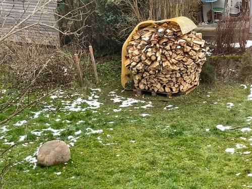 a pile of fire wood sitting on the grass at ZwergDackelAdlerHirsch in Beuron