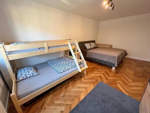 a room with two bunk beds and a couch at Apartmán Víšek in Jáchymov