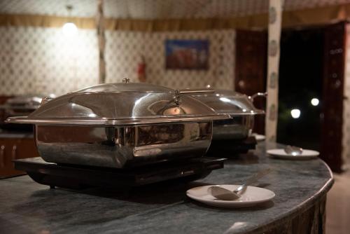 a slow cooker sitting on a counter with a plate at Atithi Camp & Resort in Pushkar