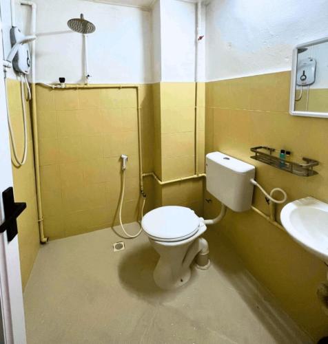a bathroom with a toilet and a sink at ASLAH BOUTIQUE HOTEL in Kota Bharu