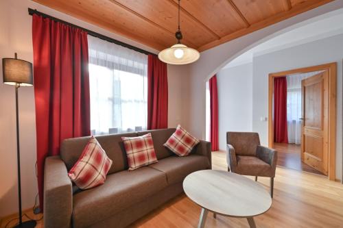 a living room with a couch and a table at Helmerhof in Schwangau