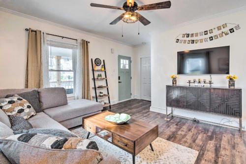 a living room with a couch and a tv at Greenville Escape with Deck and Fire Pit! in Greenville