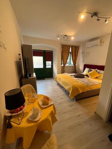 a bedroom with two beds and a table with plates on it at Titius Apartment in Skradin