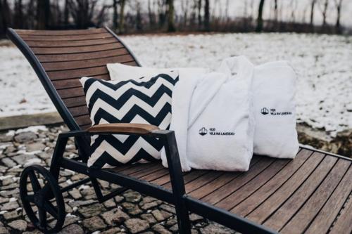 two towels are sitting on a bench in the snow at Vila Na Landeku in Ostrava