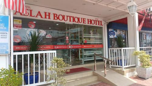 a store front of a building with a sign that readsnatural boutique hotel at ASLAH BOUTIQUE HOTEL in Kota Bharu
