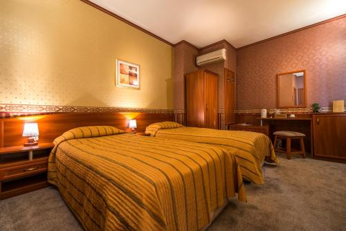 a hotel room with two beds and a bathroom at Family Hotel Chiplakoff in Burgas City