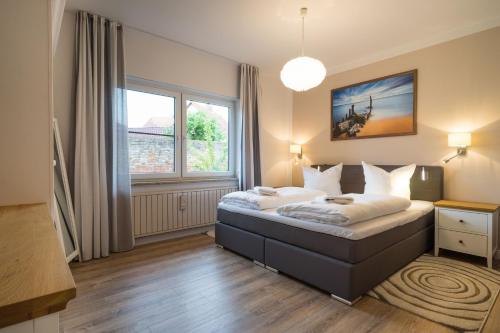 a bedroom with a bed and a large window at Ferienhaus Jule in Pudagla
