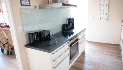 a kitchen with a counter with a stove top oven at Seehaus Plön in Plön