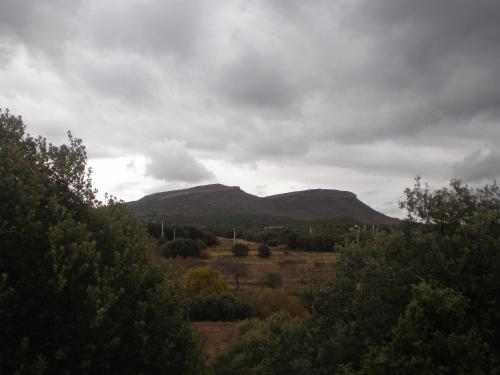 a view of a field with mountains in the background at Vivienda Turística el Ciclamen in Mora de Rubielos