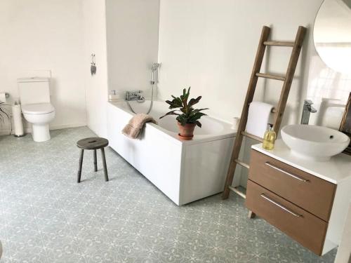 a bathroom with a sink and a tub and a toilet at Cosy Farmhouse Escape in Monmouthshire in Wolves Newton