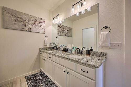 a bathroom with a sink and a mirror at Newly Built Bella Vista Home Near Lakes in Bella Vista