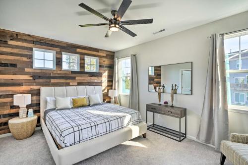 Un dormitorio con una cama y una pared de madera. en Durham Vacation Rental with Community Pools!, en Durham