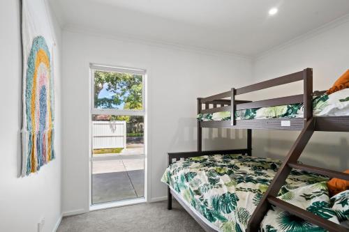 a bedroom with a bunk bed and a window at Contemporary Comfort - Masterton Holiday Home in Masterton