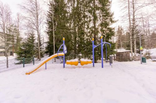 a playground with a slide in the snow at Valoisa huoneisto jossa erinomaiset vuoteet. in Mikkeli