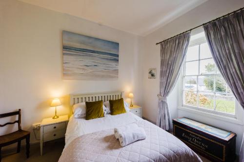 a bedroom with a bed and a large window at May Tree Cottage Manorbier 5 mins from the beach Sleeps 4 in Manorbier