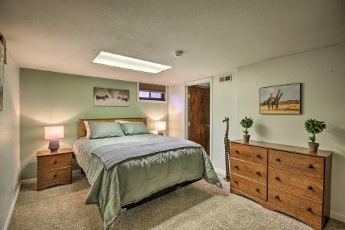a bedroom with a bed and a dresser and a window at Billings Apartment with Fireplace and Smart TV in Billings