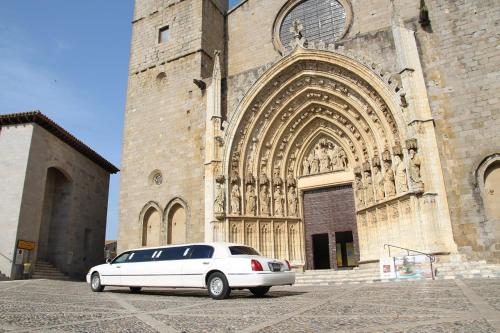 a white car parked in front of a church at Ampuria Inn in Empuriabrava