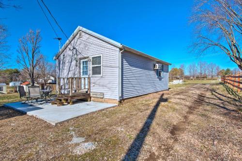 a small house with a porch and a yard at The Brewer Guesthouse Tiny Home with Patio and Yard! in Perryville