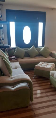 a living room with a large couch and a window at Casa N Campestre en las faldas del Taita Imbabura in San Juan de Ilumán