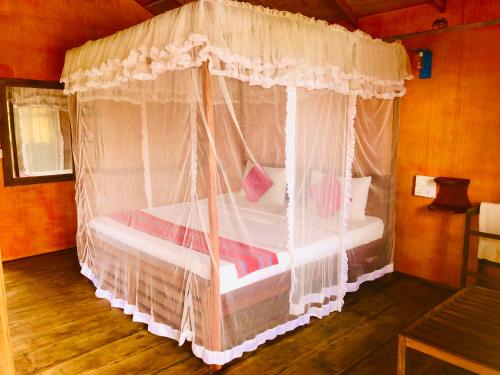 Postel nebo postele na pokoji v ubytování Sungreen Cottage Sigiriya