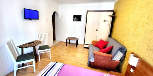 a living room with a couch and a table at Cozy Studio Floreasca in Bucharest