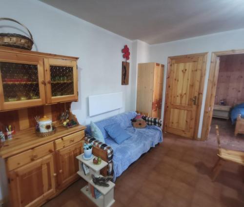 a bedroom with a blue bed and wooden cabinets at La casa di Fantalegno in Camigliatello Silano