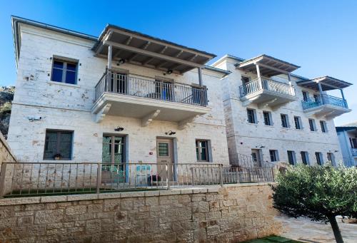 a large stone building with balconies on it at Haones Suites in Ioannina