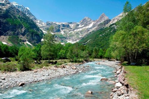 a river in a valley with mountains in the background at Pirineos como en casa in Bielsa
