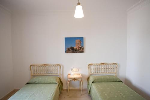 two beds sitting next to each other in a room at Llampudol -Villa Sa Coma- in Sa Coma