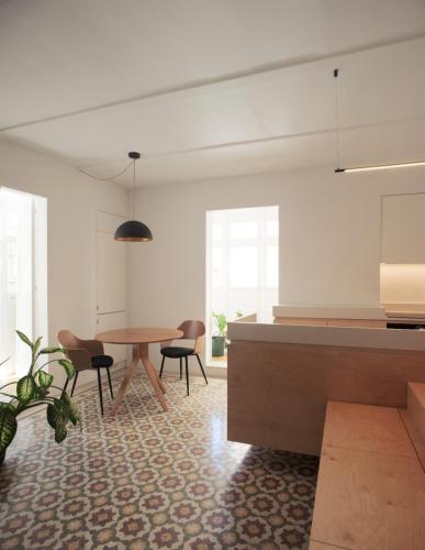a kitchen and dining room with a table and chairs at Valletta Collection - Floriana Maisonette in Il-Furjana